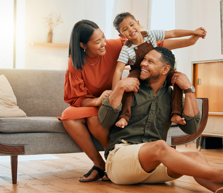 Family smiling together on a couch