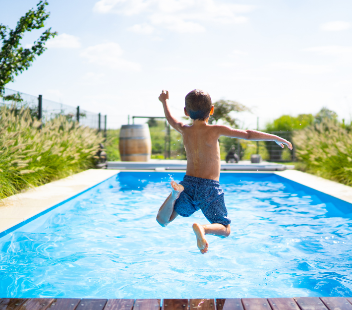 Kid jumping into pool