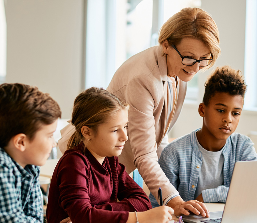 Image of a teacher helping students