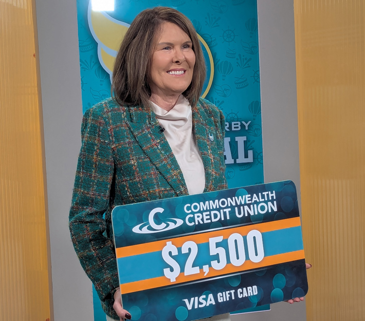 Photo of Karen Harbin holding an oversized gift card