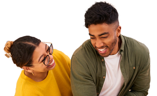 Man and woman smiling together in a kitchen.