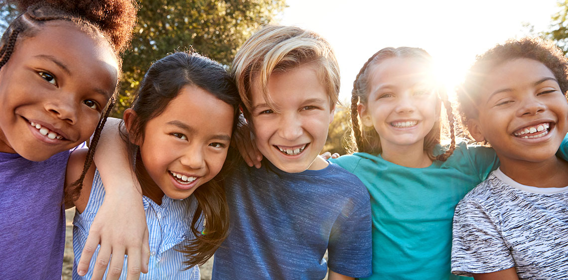 Group of pre-teen kids posing for picture